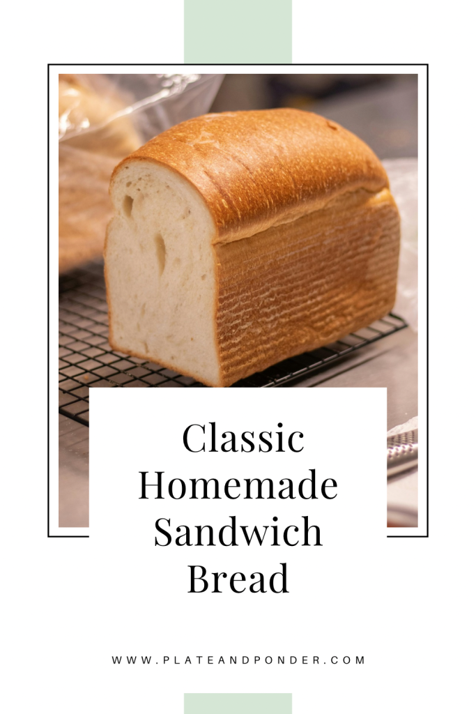 Loaf of sandwich bread with overlaid text “Classic Homemade Sandwich Bread”.