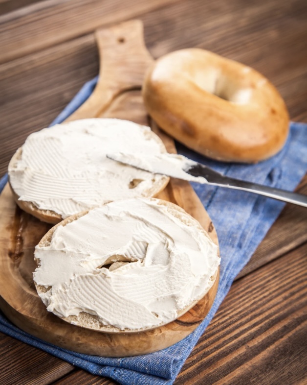 A bagel with a generous amount of homemade cream cheese.
